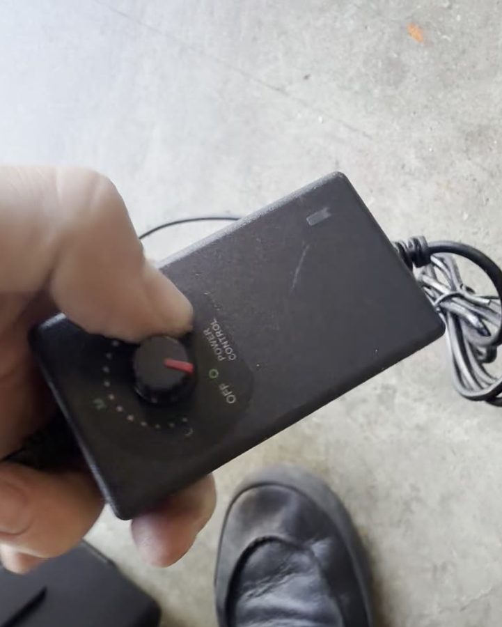 Hand turning the inline fan speed knob