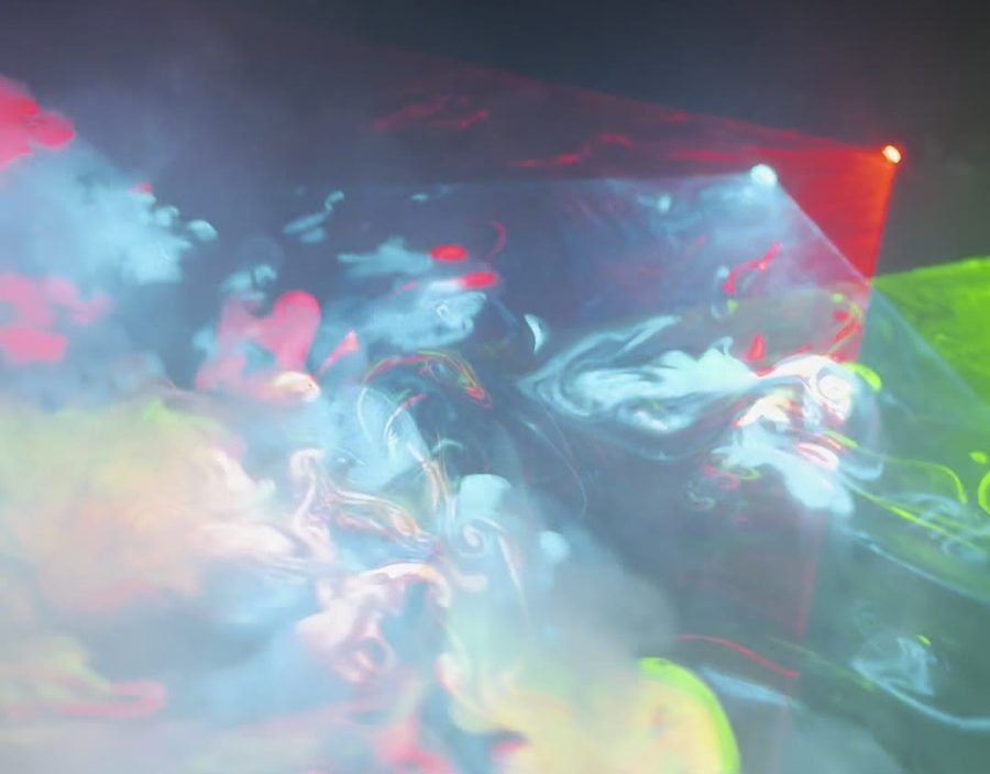 Close-up of red and green laser curls in the fog