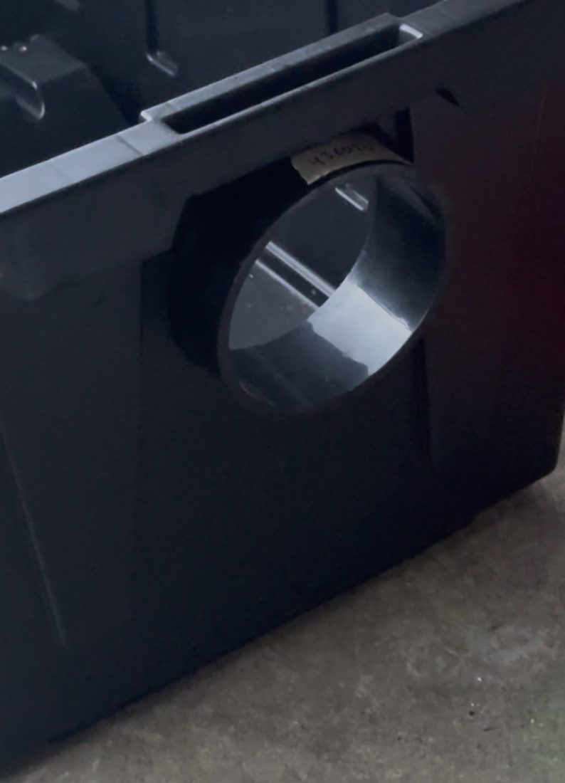 Pipe fitted through the bin wall