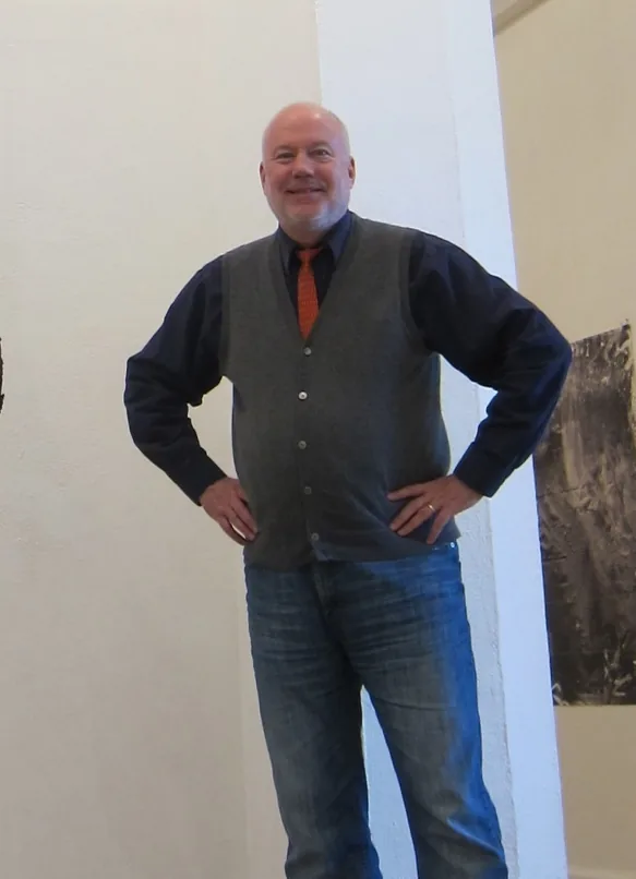 Kim Strommen standing with his hands on his hips in a white gallery