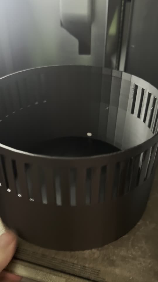 The black slotted outer shell fresh off the 3D printer